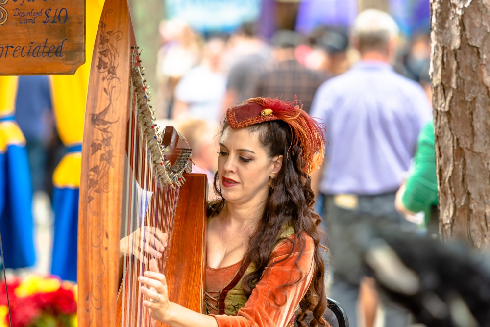 A Musician plays the harp at the georgia renaissance festival