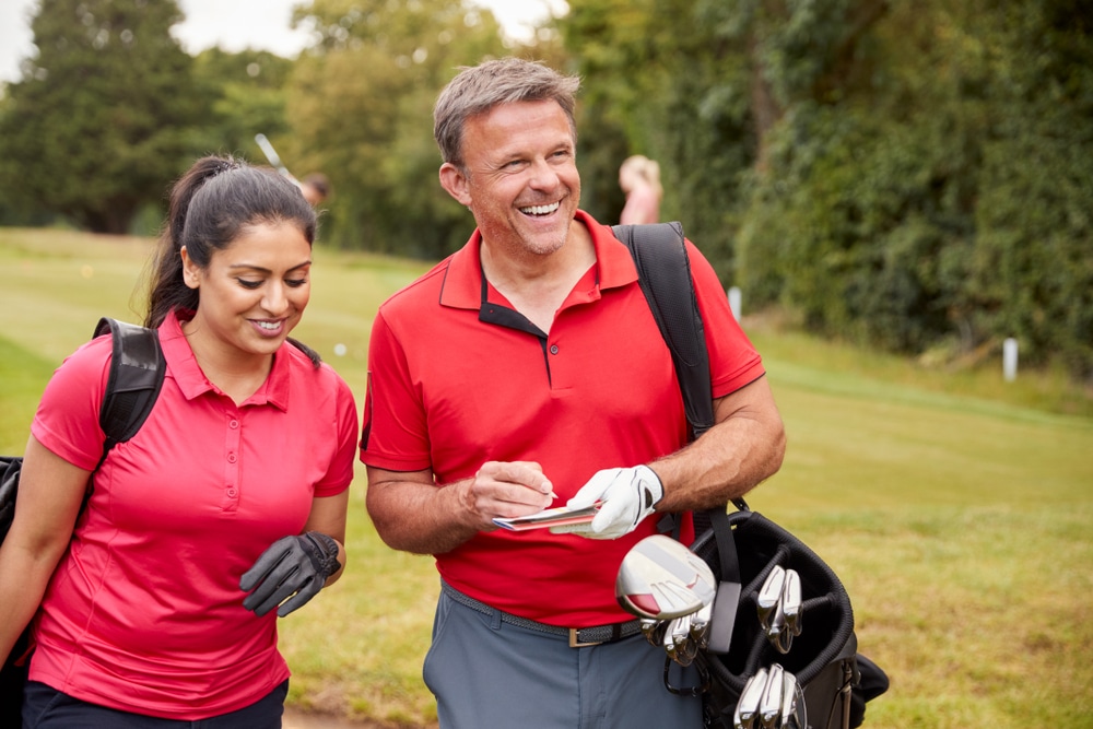 Things to do in Peachtree City, photo of a happy couple hitting the golf course in Georgia