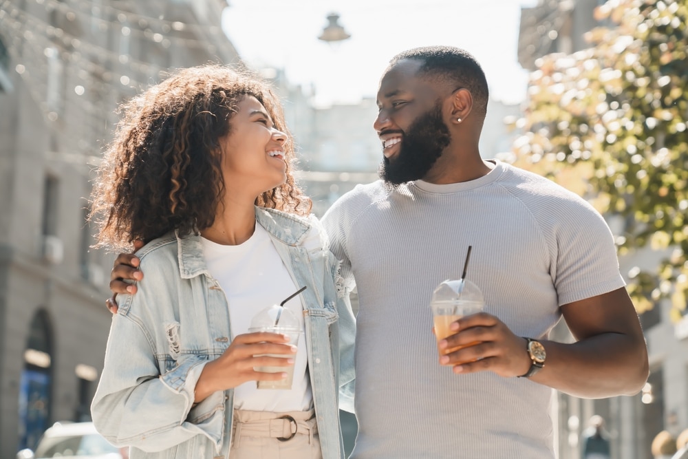 things to do in Peachtree City, GA, happy couple walking with iced lattes and window shopping 